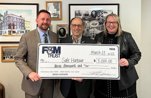 United Bank Limited representatives present a large check to Safe Harbour